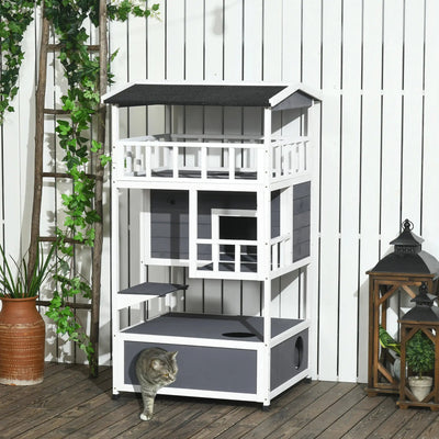 Three-floor outdoor cat playhouse with balconies and a cat enjoying the different levels