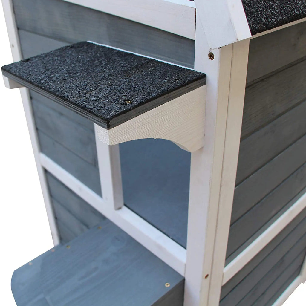 Wooden steps on cat house with a black top and gray sides on a white background
