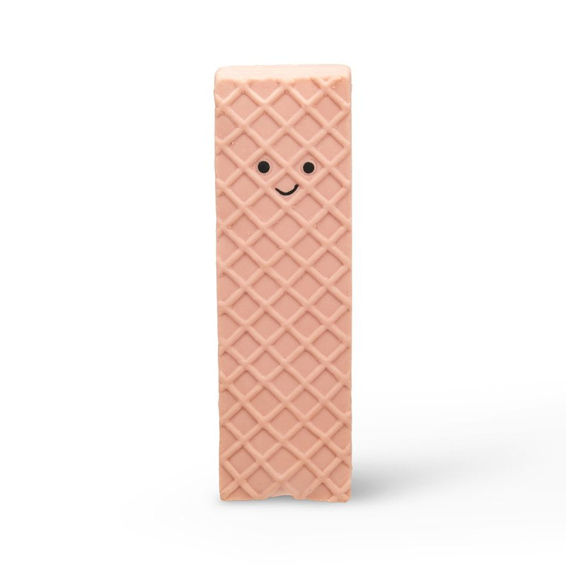 Pink wafer cookie-shaped block with a smiley face on a white background