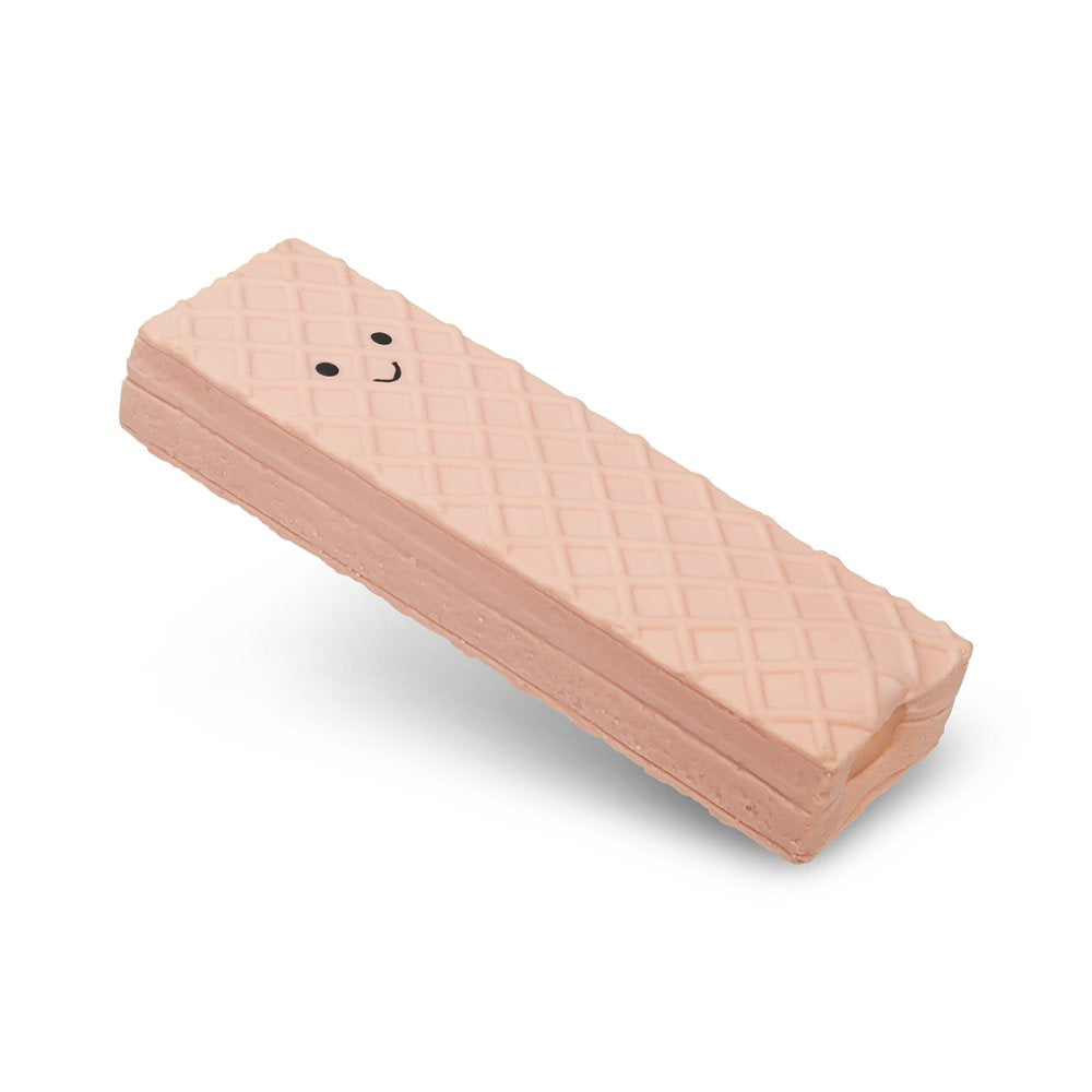 A pink wafer with a smiley face on a white background