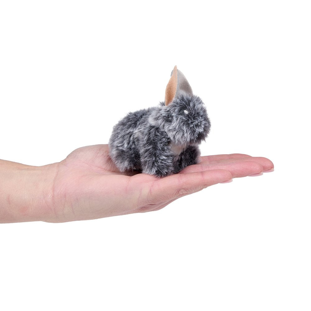 Small gray plush animal held in a hand on a white background
