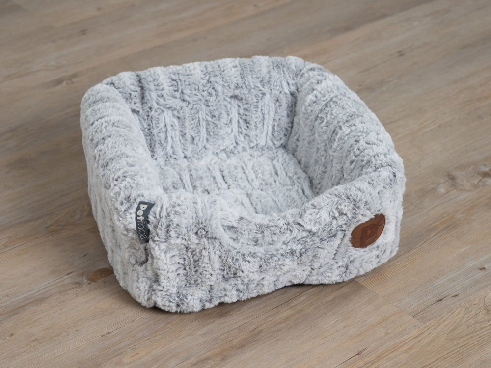 Fluffy pet bed on a wooden floor
