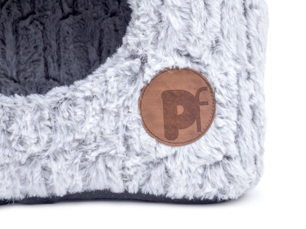 Close-up of a textured product with a brown leather patch featuring a logo on a white background