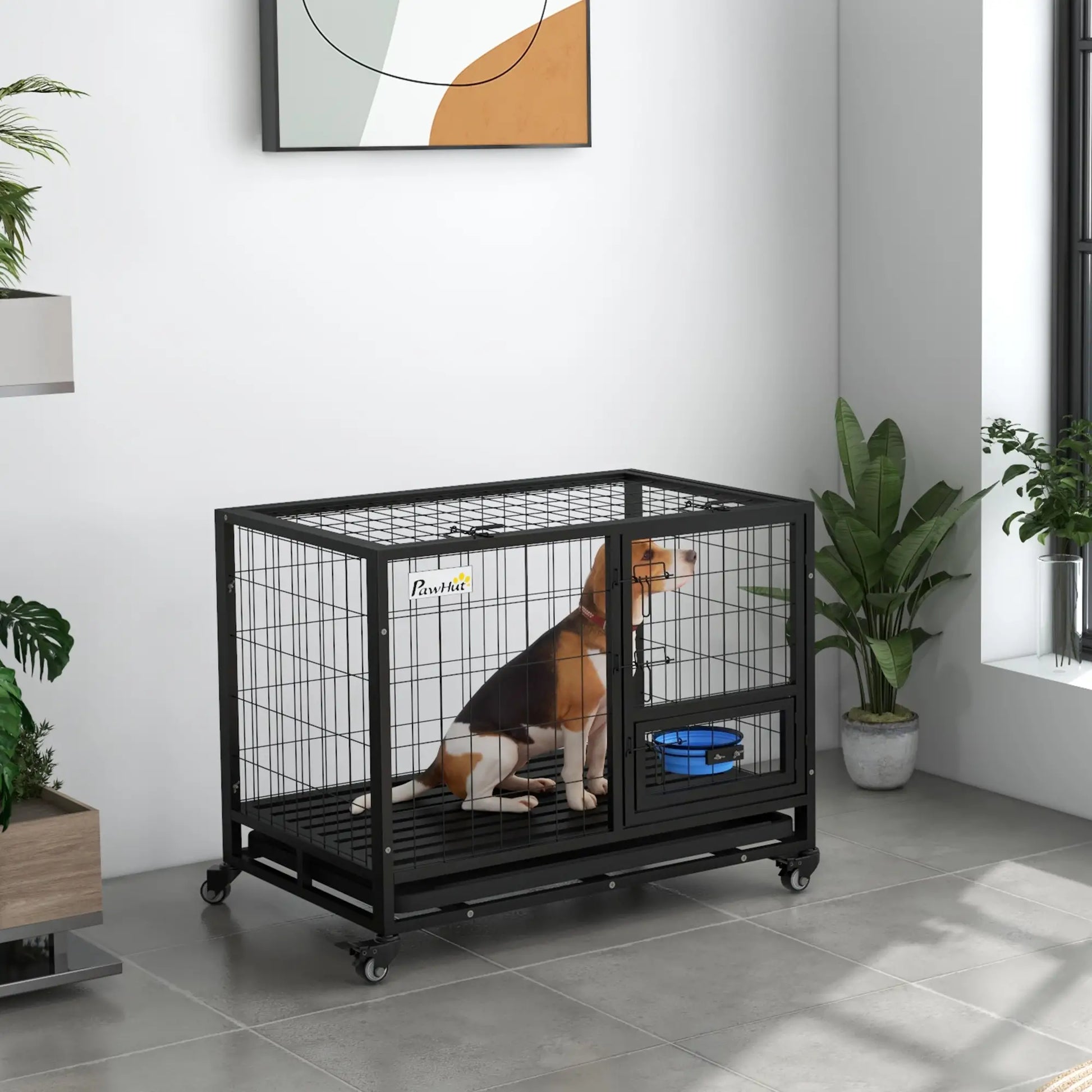Dog in a black crate in a room with plants and a painting on the wall