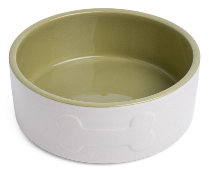 Two-toned ceramic bowl with green interior and white exterior on a white background