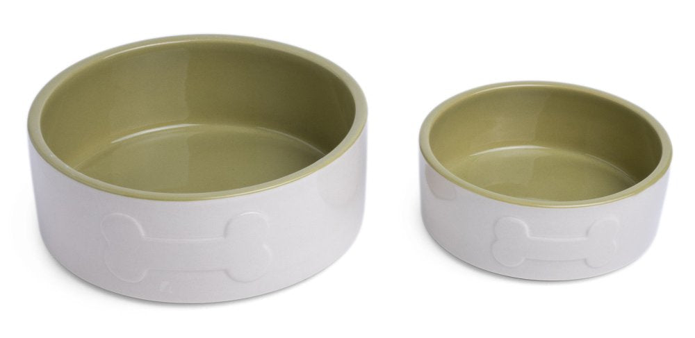 Green and white ceramic dog bowls on a white background