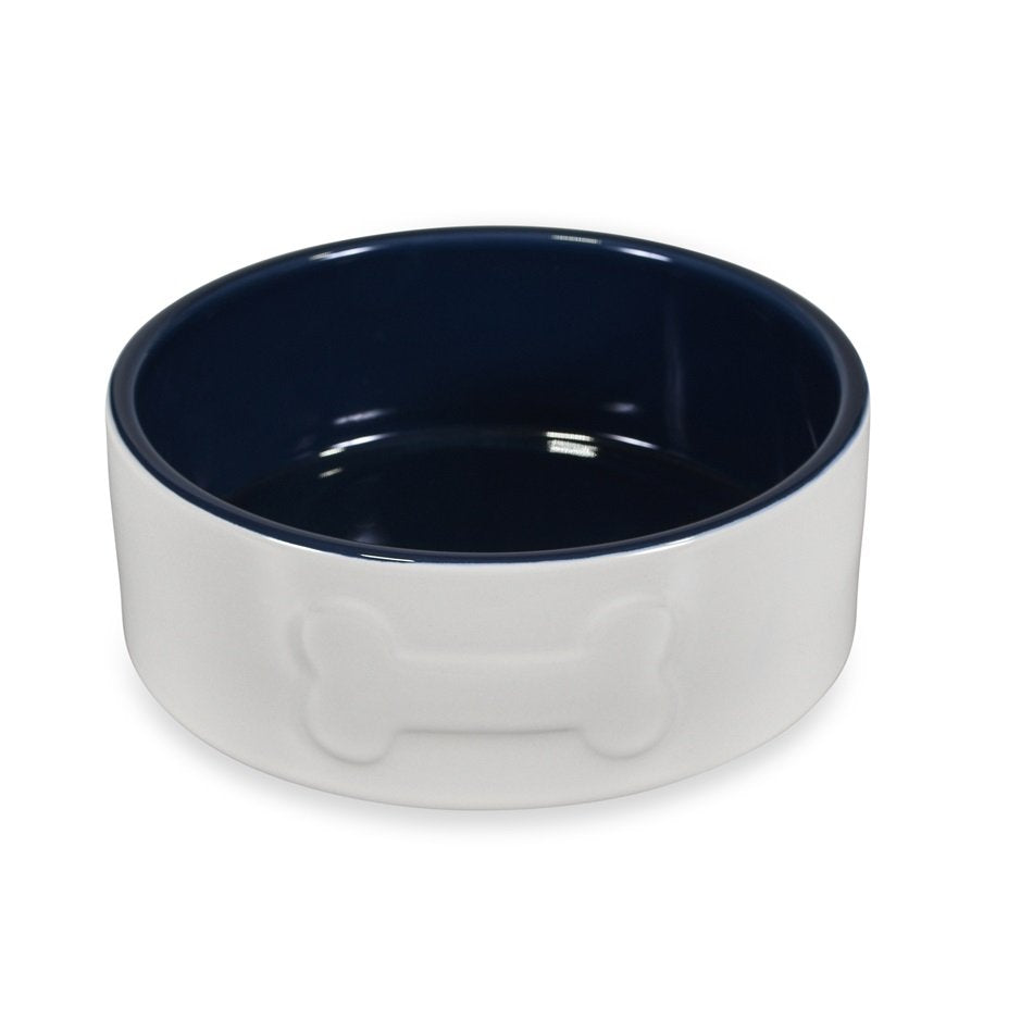 Dog bowl with white base and navy interior on a white background