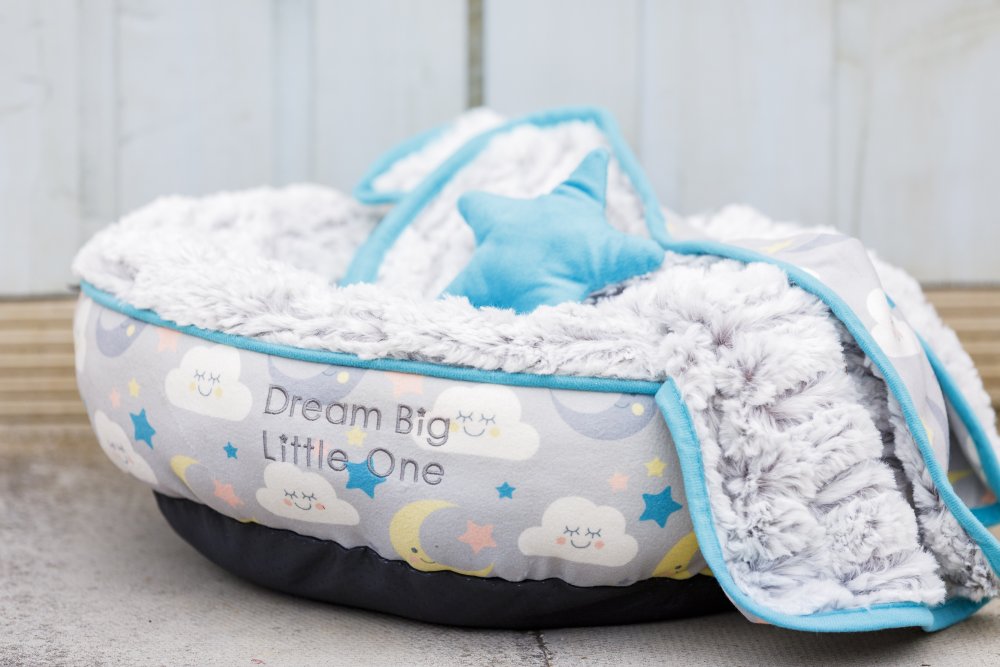 Pet bed with soft blanket and pillow, featuring 'Dream Big Little One' text.