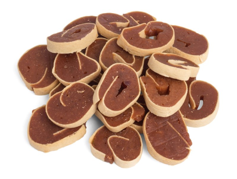 Stack of brown dog treats on a white background