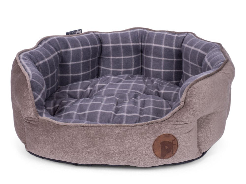 Pet bed with plaid interior and brown exterior on a white background