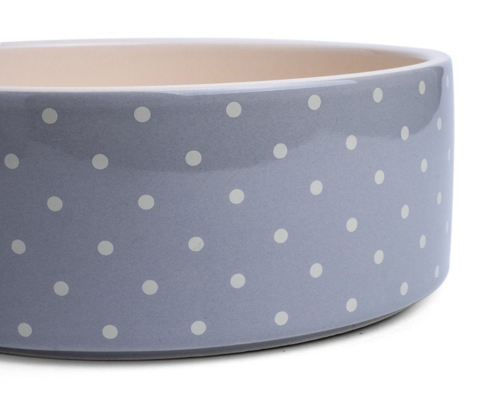 Gray bowl with white polka dots on a white background