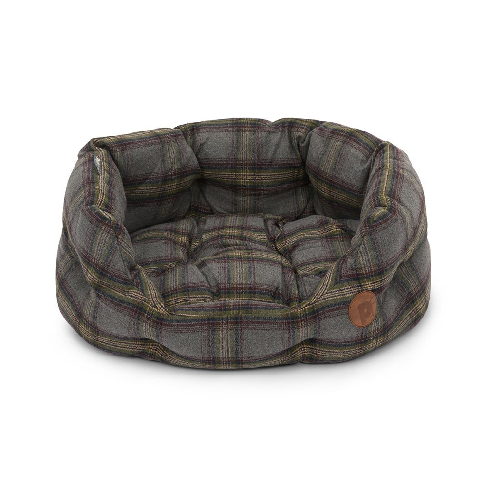 Plaid patterned pet bed with a brown label on a white background