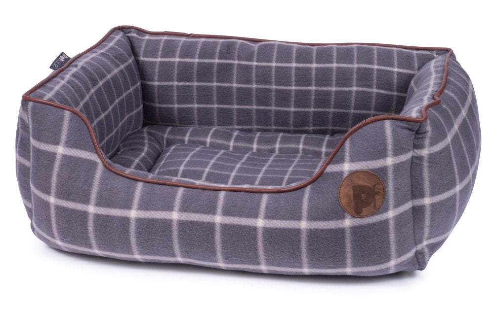 Plaid patterned pet bed with brown trim on a white background