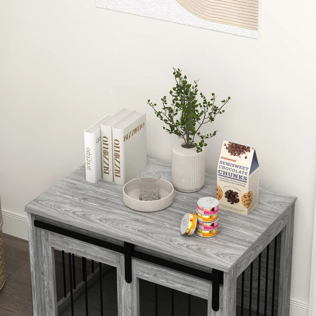 Small wooden table with decorative items including books, a plant, and a box on a white wall background.