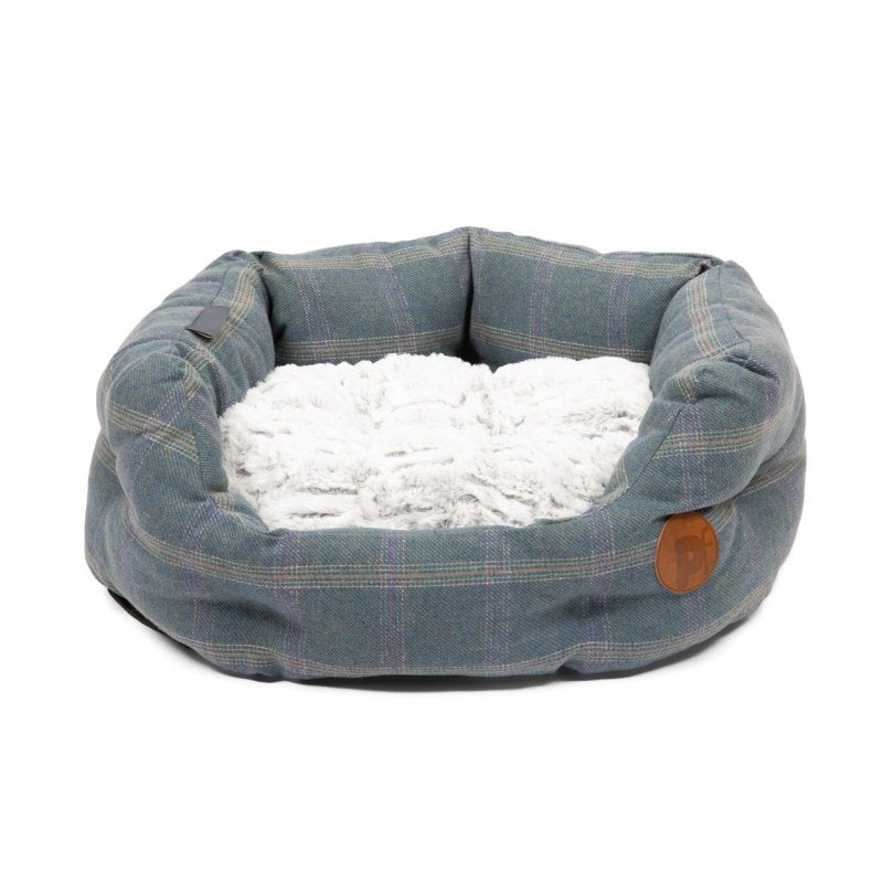 Dog bed with plaid pattern and white cushion on a white background
