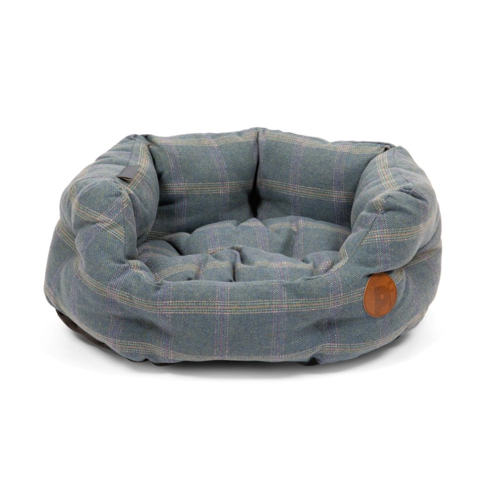 Blue plaid pet bed with a brown leather tag on a white background