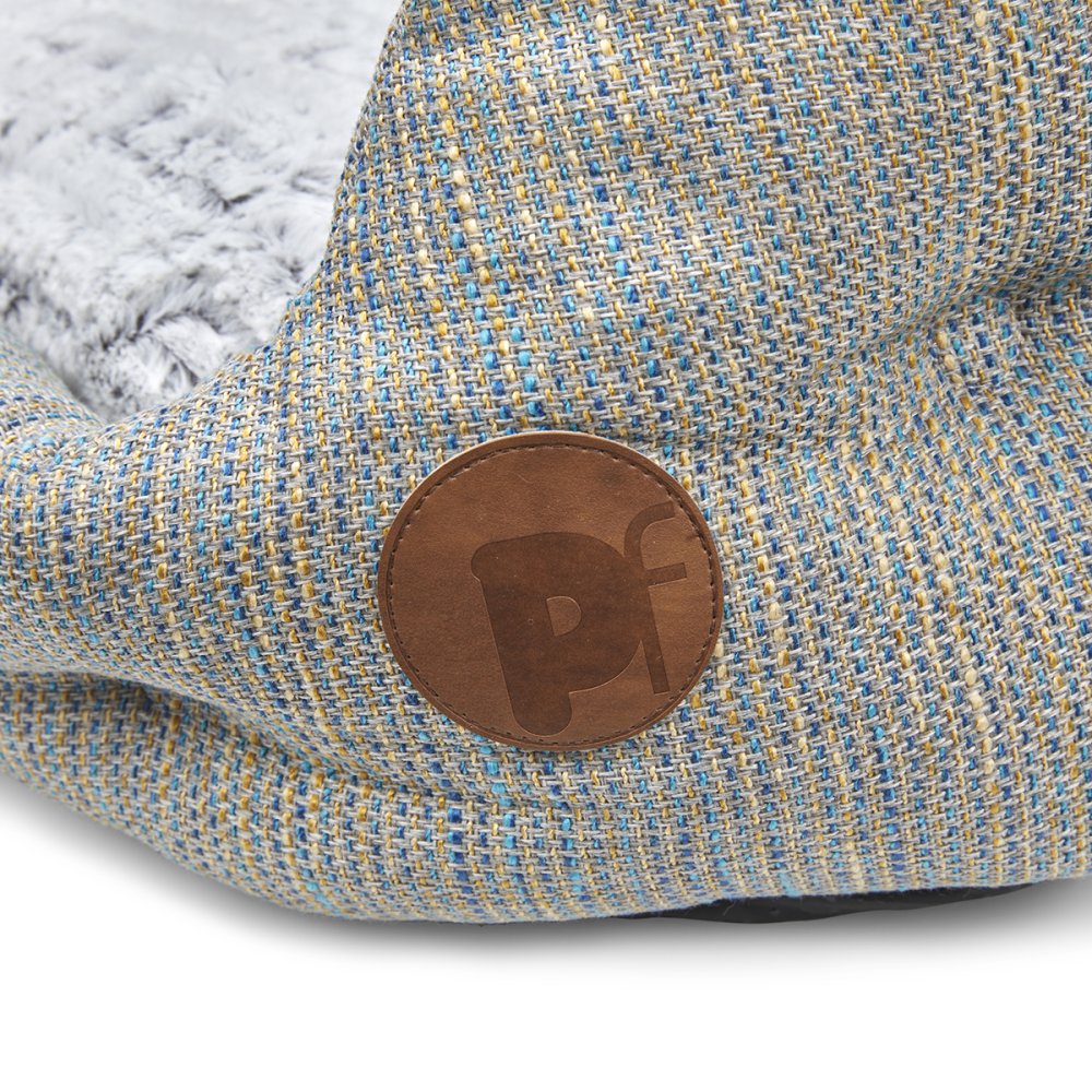 Textured fabric surface with a brown leather patch featuring 'Pf' logo.