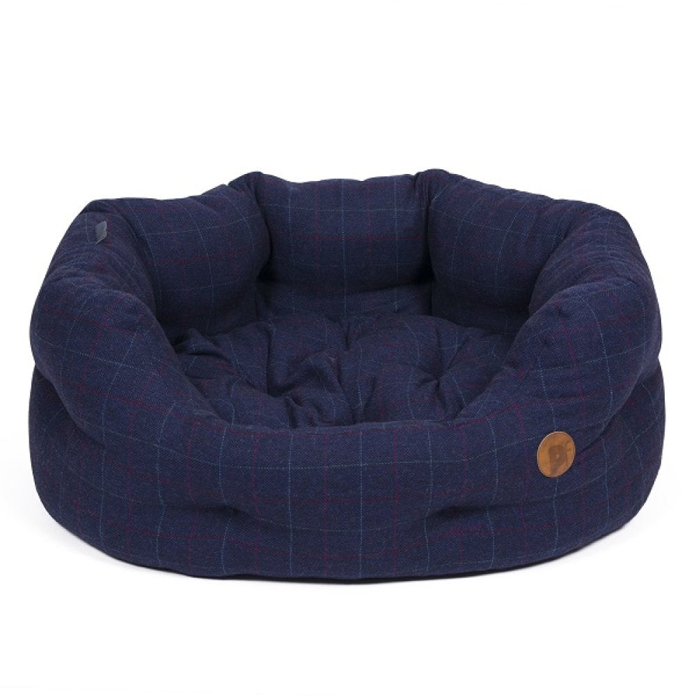 Navy checkered pet bed with a brown button on a white background