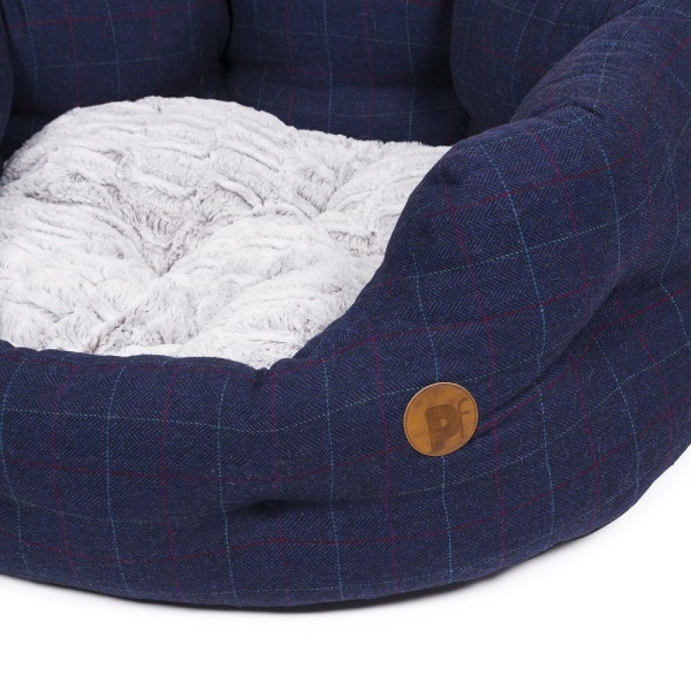 Blue checkered pet bed with white cushion on a white background