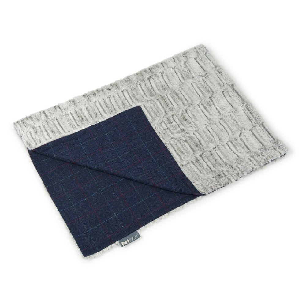 Folded fabric with gray textured top and navy checkered bottom on a white background