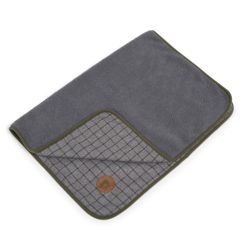Gray and green textured blanket with a brown circular object on a white background