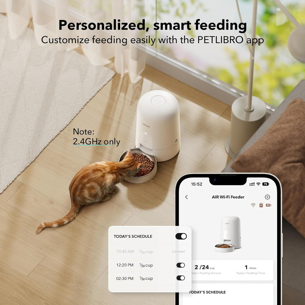 Cat eating from a smart pet feeder with smartphone app interface displayed.