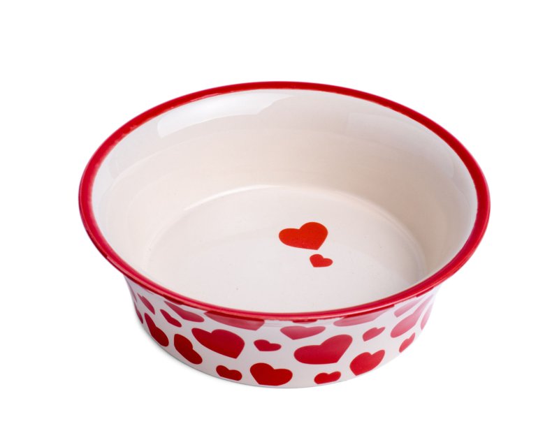 White bowl with red heart patterns on a white background