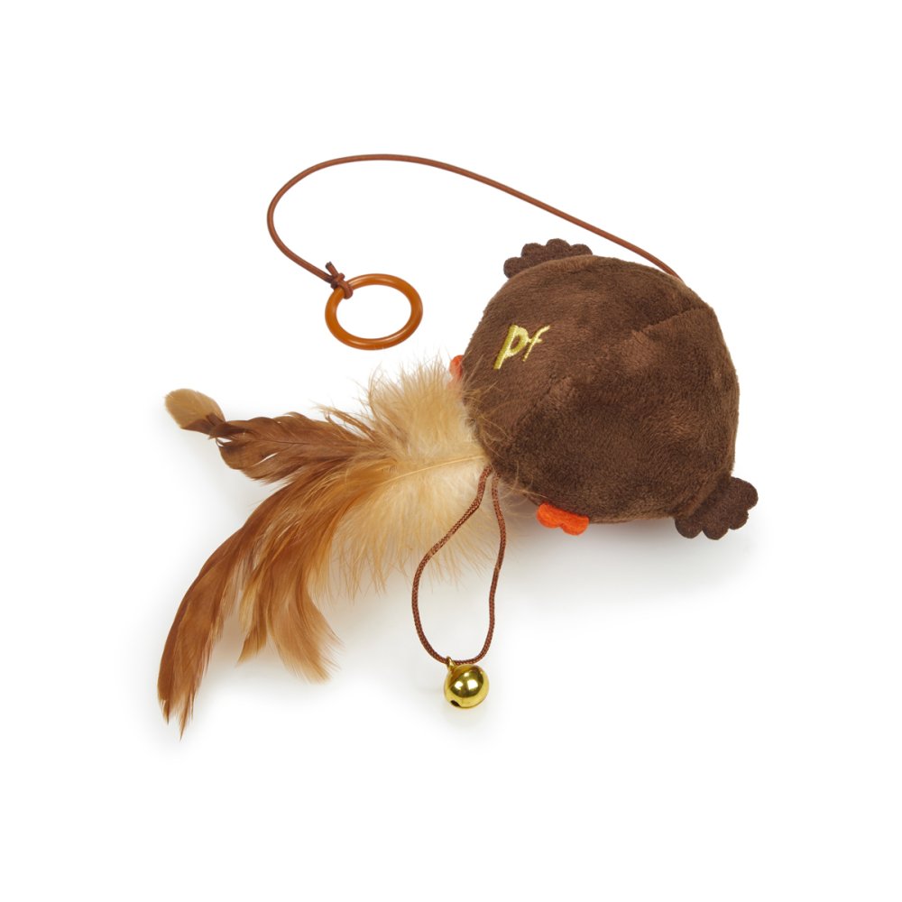 Brown plush toy with feather and bell on a white background
