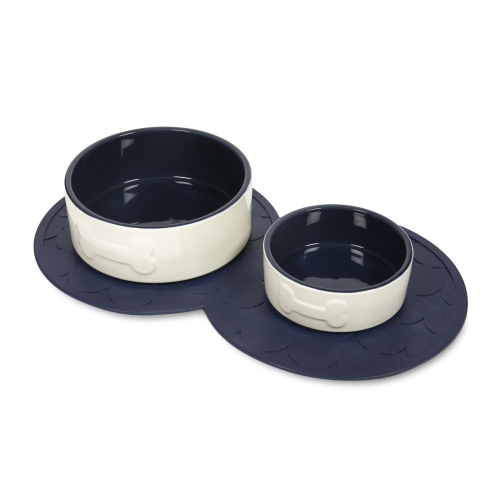 Two navy rubber pet placemats beside ceramic bowls