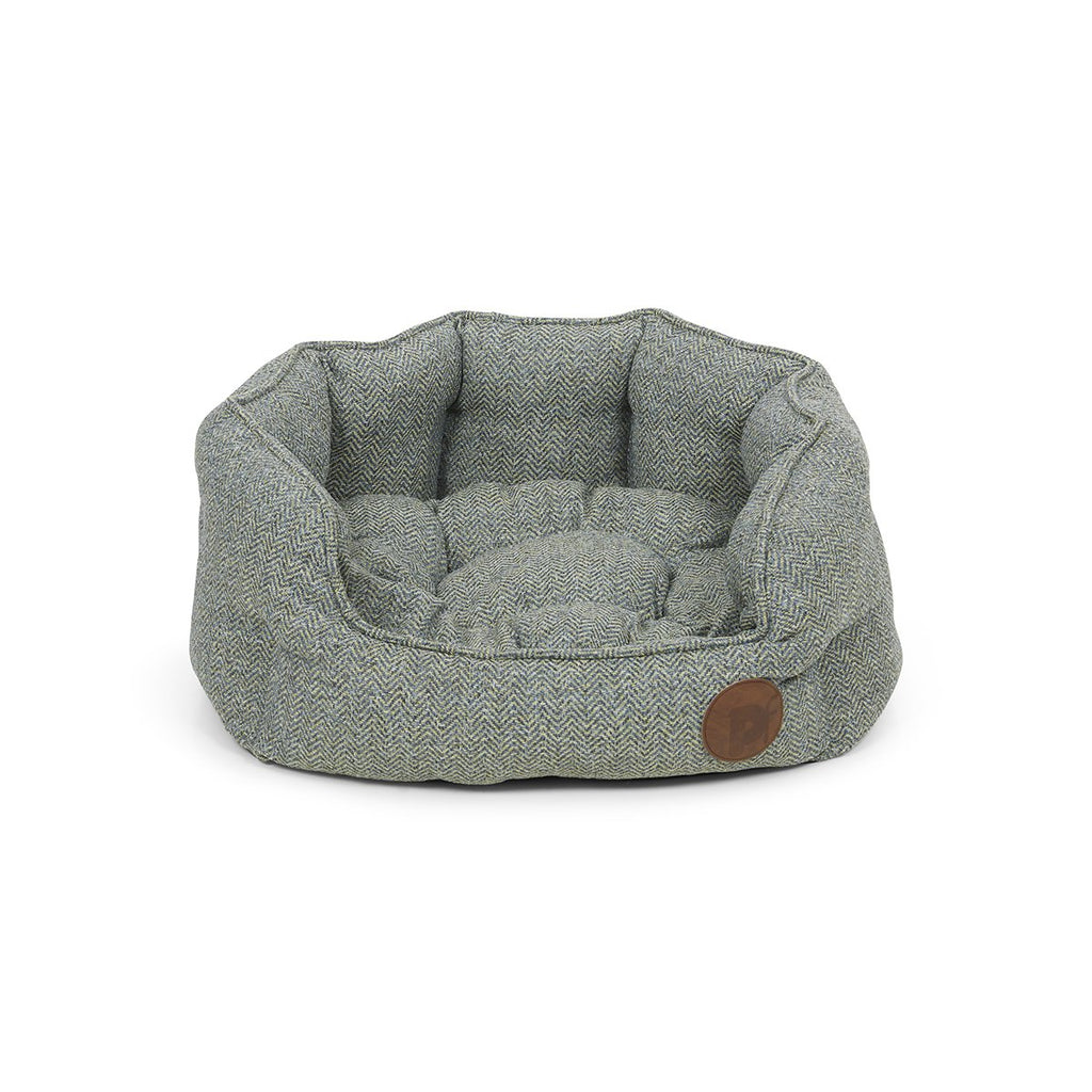 Gray pet bed with a brown leather tag on a white background