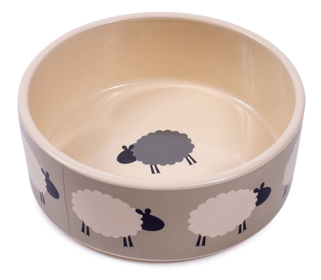Beige pet bowl with sheep pattern on a white background