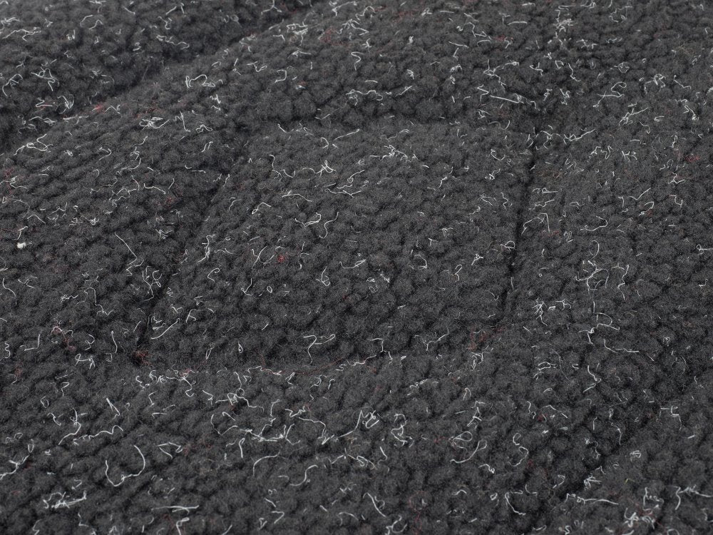 Close-up of textured dark gray fabric with a subtle pattern