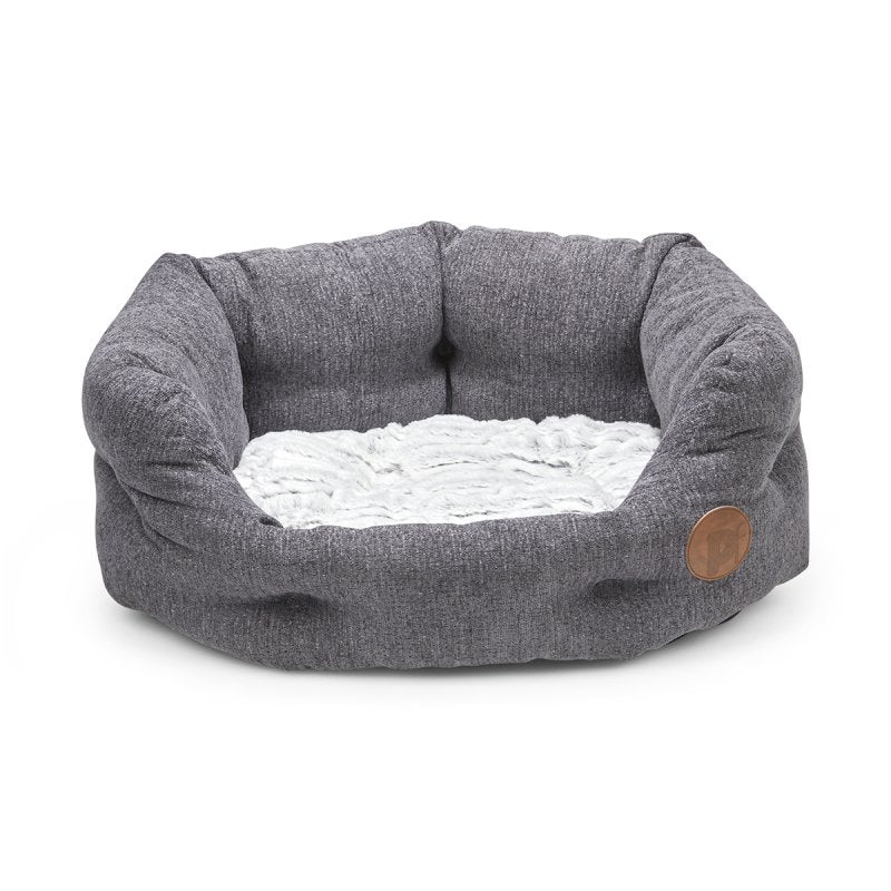 Gray pet bed with a white cushion on a white background