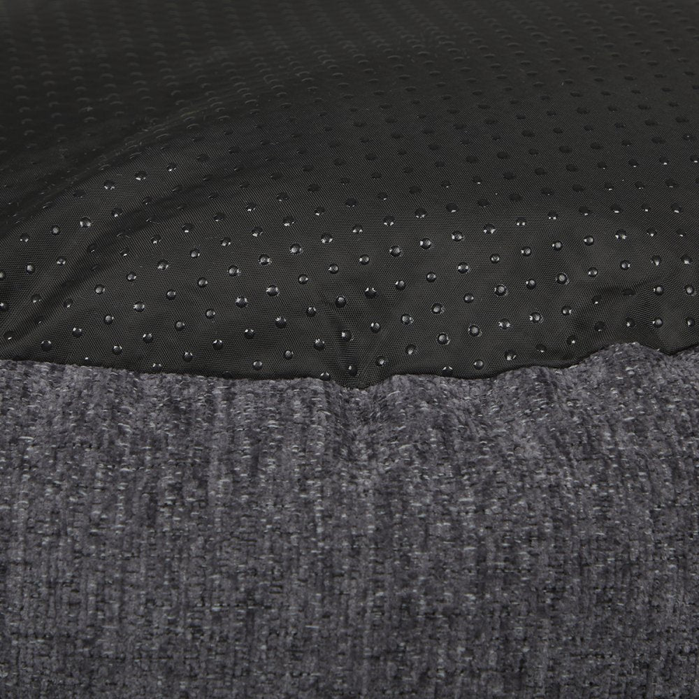 Close-up of black textured fabric with a gray surface underneath