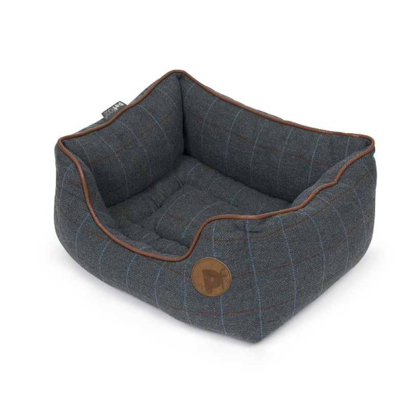 Dog bed with plaid pattern and brown trim on a white background