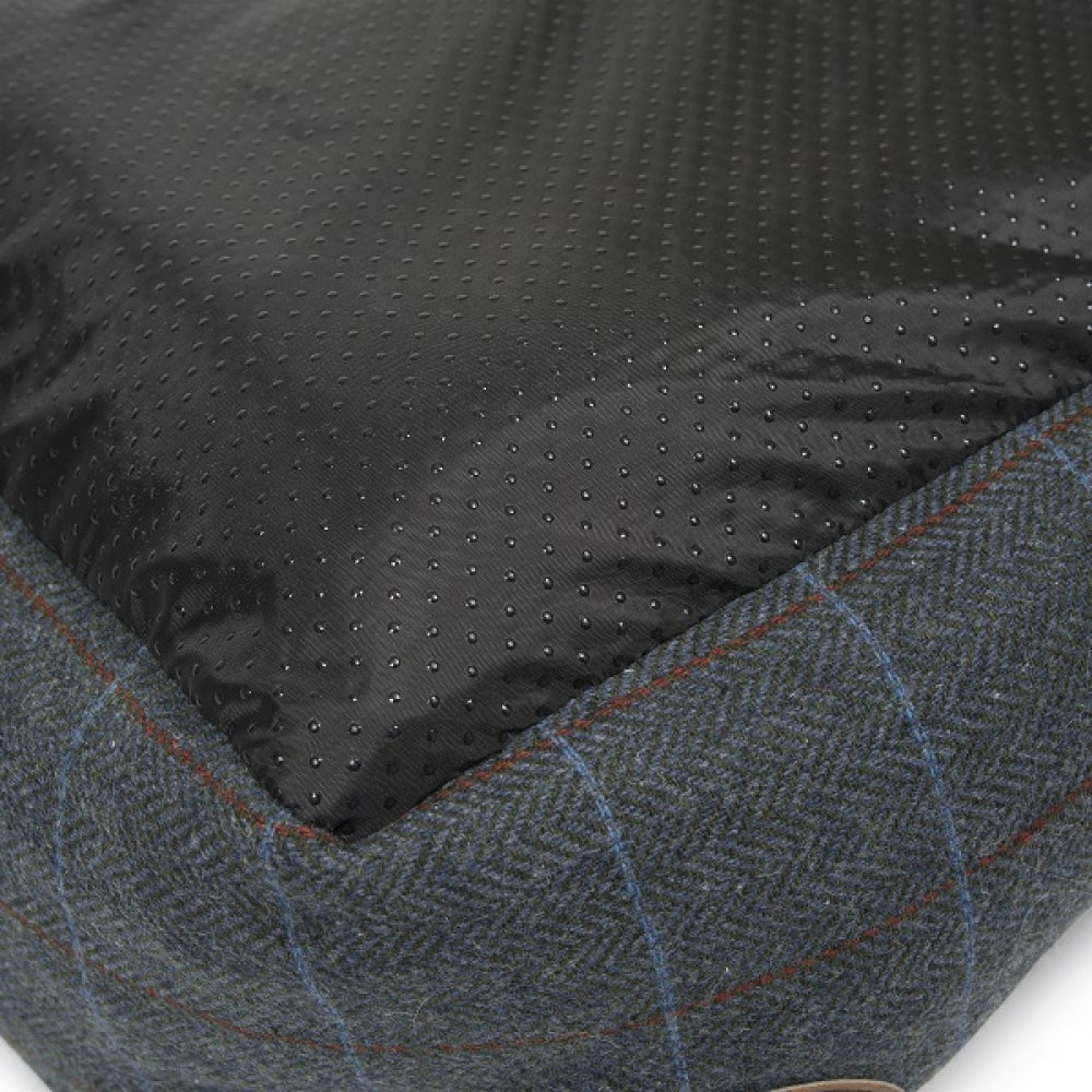 Close-up of a textured black fabric surface with a patterned gray border.