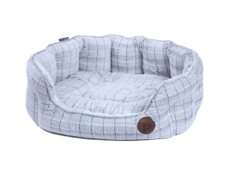 Dog bed with plaid pattern and brown button on a white background
