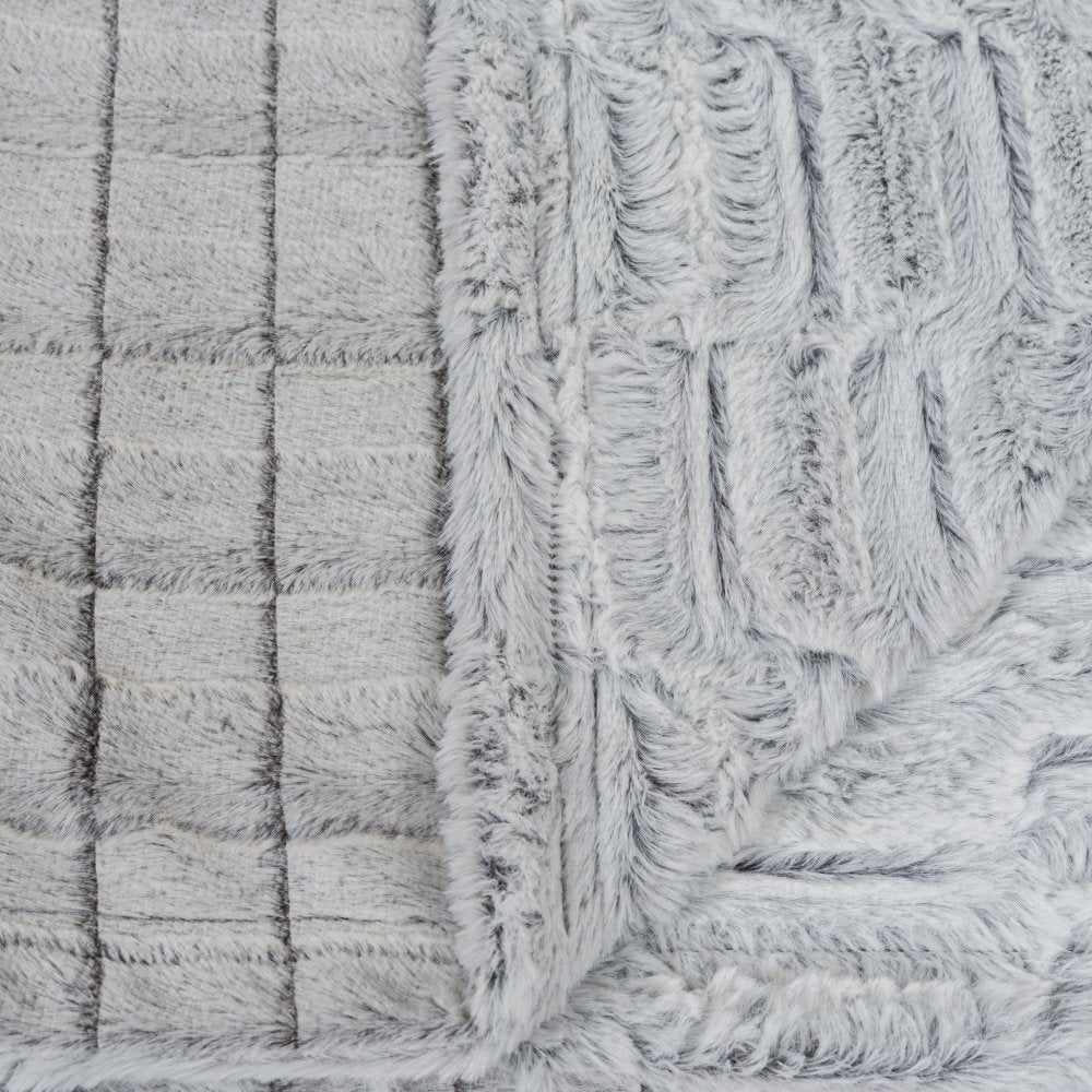Close-up of textured fabric with a checkered pattern and frayed edge.